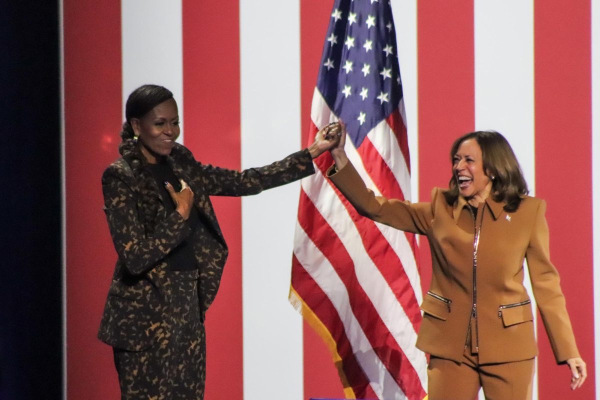 Harris and Obama unite and the end of the rally as the audience cheers them on. 