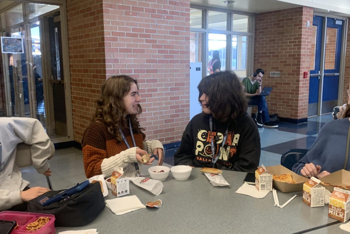 Freshman Eleanor Pittelko laughs with friends during lunch in the cafeteria. All the worry about past assignments and tests is relieved when she starts a conversation with her friend, Savannah Smith.