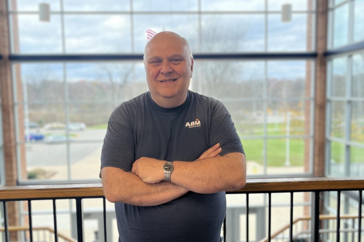 Custodian John Deavies stands proud in front of his workplace of twenty-one years. Despite Deavies extensive career at Loy Norrix, few knew who he was. 
