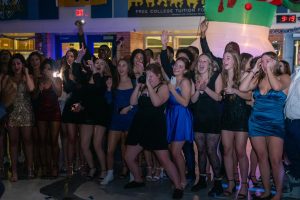 A group of students get down while forming a dance circle. These dance circles are frequent features of school dances.
