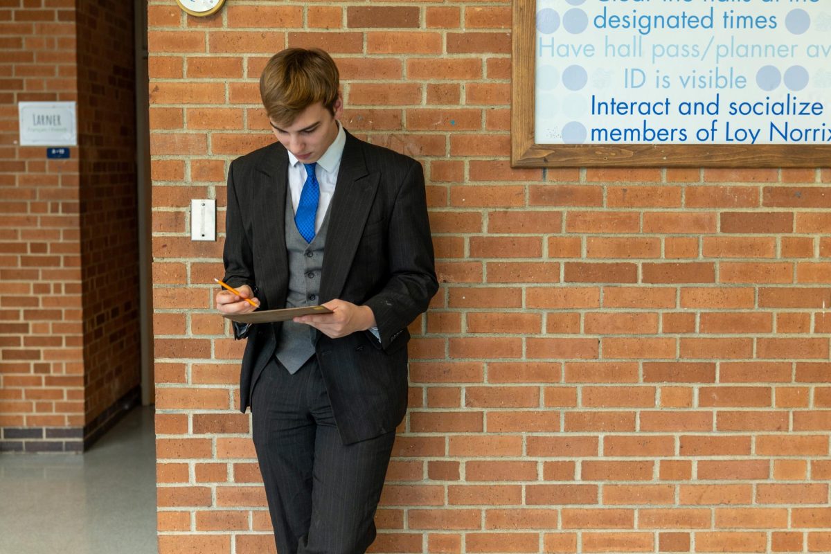 Senior Fletcher Haase makes up a test for his French class in the hallway. With winter break quickly approaching, students are working hard to keep their grades up.