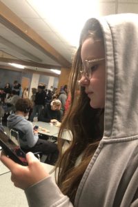 Freshman Lauren Whittle goes against the dress code and wears a hood inside her school cafeteria. Whittle is constantly seeking change in the rules surrounding the dress code at Loy Norrix.
