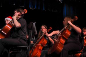 Freshmen cellist Wren Malloy accompanies the rest of the orchestra as they play a mash-up of songs from “Willy Wonka & the Chocolate Factory.”