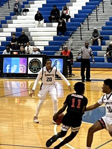 Sophomore Rashad Mitchell plays defense against a player on the Falcons. Rashad hopes to follow his father's footsteps as a professional basketball player.