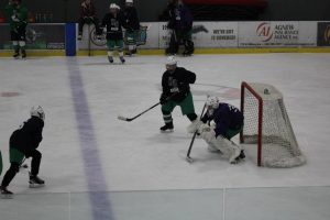 Jude Brott prepares to take a shot at Lucas Buehner in the Wings West Arena during practice. They are working on taking accurate shots. 