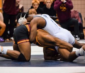 Sophomore Darik Smith holds down KC wrestler as he is looking to secure a pin, Smith ended up winning his match after this round.