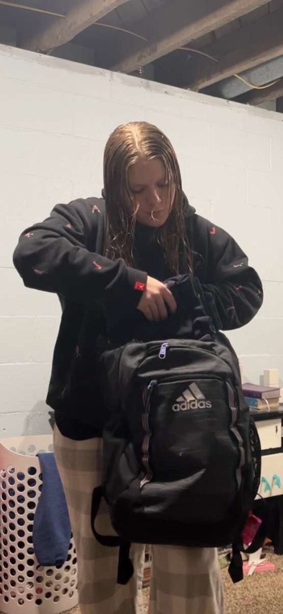 Sophomore Shyanne Weston packs her backpack at her mom's house, preparing to go to her dad’s. On Fridays, she and her brother switch parents' houses.