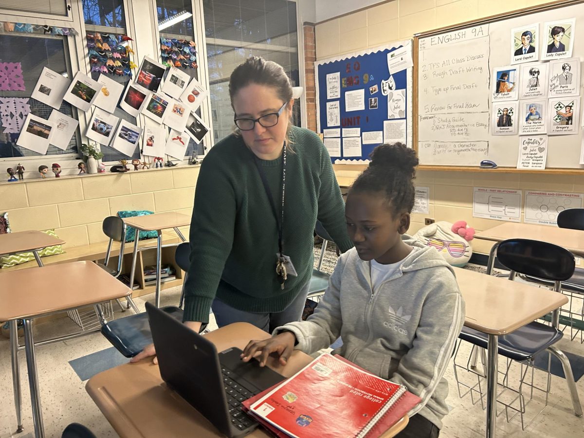 In the morning before class starts, history teacher Samantha Devries helps her student with work on her computer. Freshman Venasia Iratuzi frequently comes into her first hour early to ask for help or to hangout with Devries. 