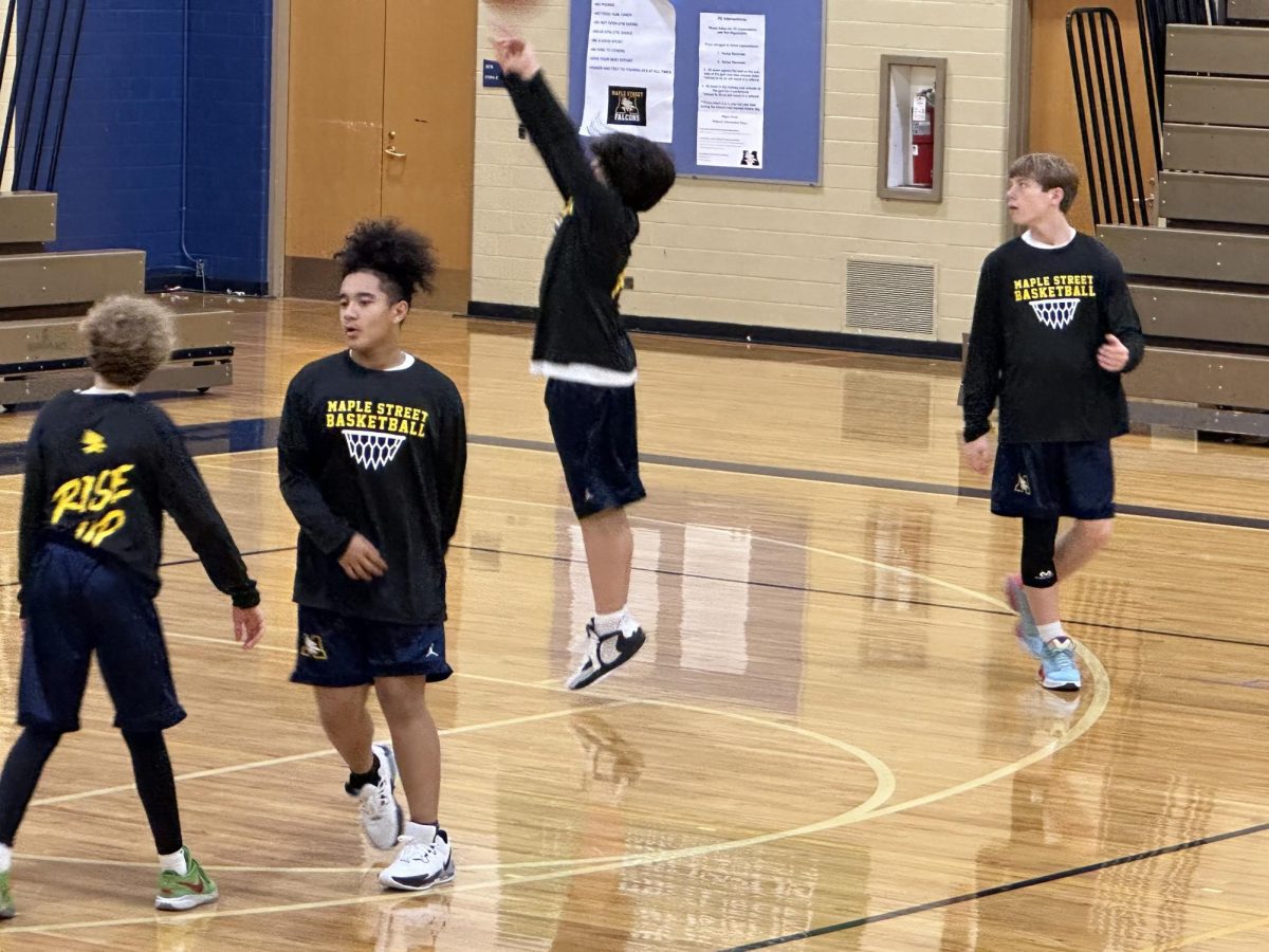 Freshman Gus Solitro and others practicing for the middle school basketball team. Solitro is practicing jump shots to get better at the game.