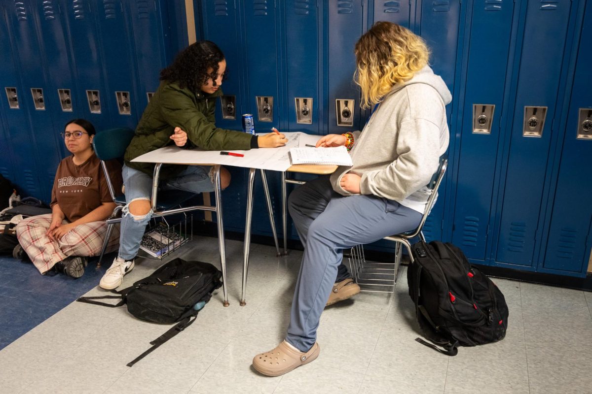  Sophomore Aubrey Graves and Brooke Van Der Westhuizen work together on a school project in the K wing hallway. Many students use the hallway to have some quiet space while they do their classwork.