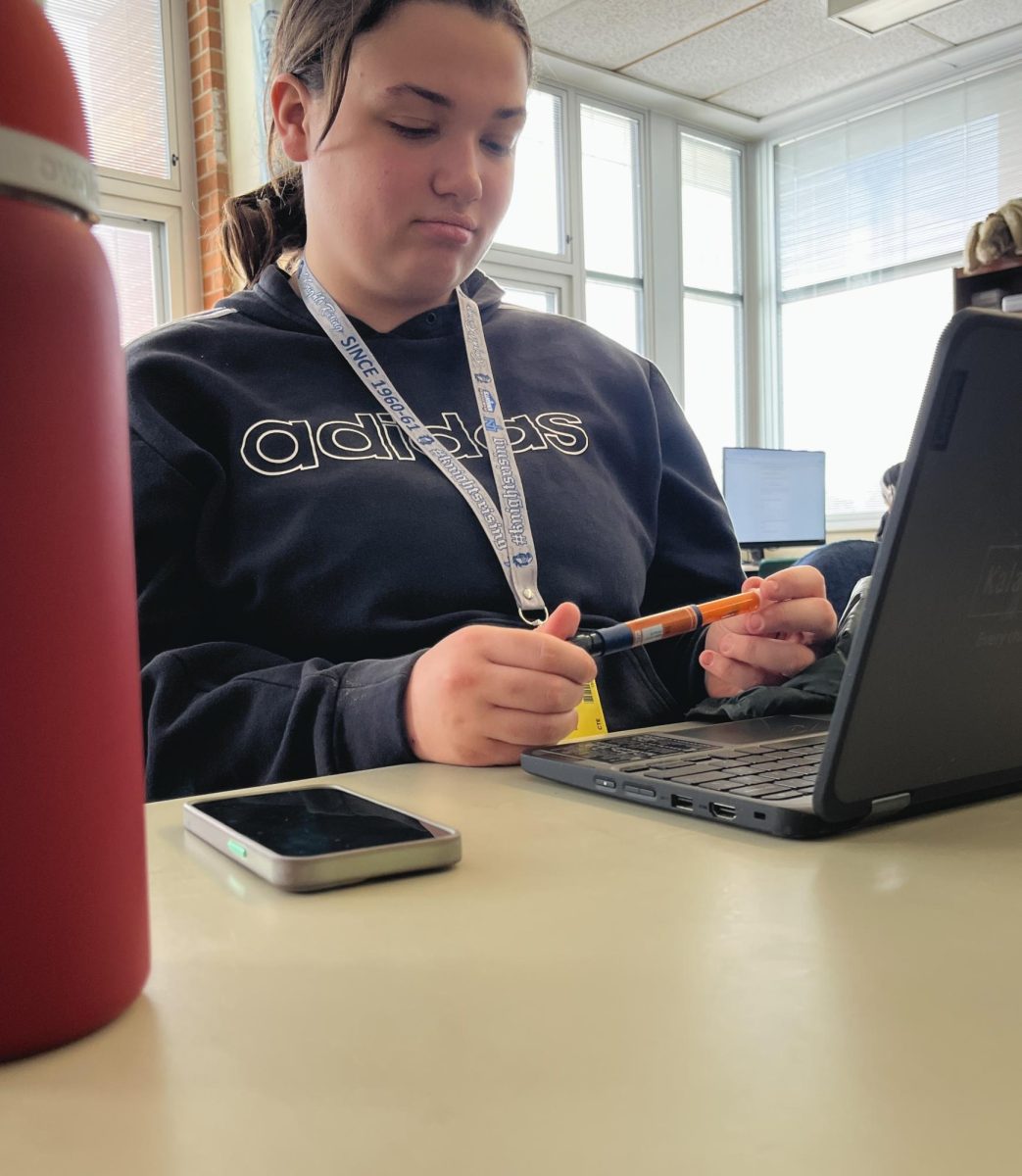 Senior Raylee Maize–Scaife debates with her Novolog insulin pen in class. Diabetics have to use a Novolog insulin pen about 15 minutes before they eat, or when their blood sugar is high.