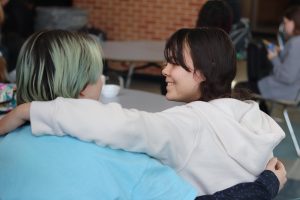 Freshmen Tommy Lepsy and Edith Whalen sit together and chat. They wrap their arms around each other and enjoy each others' presence.