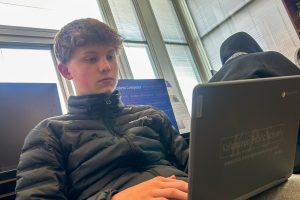 Freshman Brady Charles works on his project during Tisha Pankop’s fourth hour journalism class. He is focused on typing out his story for the assignment.