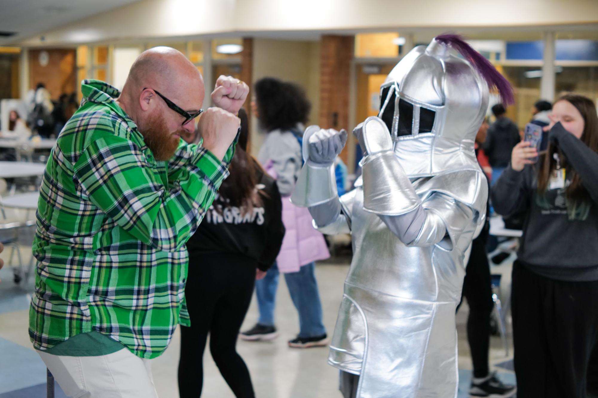  Teacher Paul Mahar and Knight Life mascot, Aurthur the Knight, face off in a dance battle. Arthur the Knight was in the cafeteria to promote the Knight Life podcast, Knights of the Round Table.   