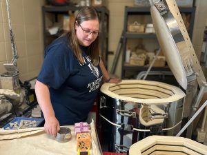 Corstange unloads her students' glazed ceramic pieces out of the kiln in the storage room next to her class. She is the only one allowed to take them out because of how dangerously hot the kiln can get at times. This is the most exciting step for a lot of students because they finally get to see their finished pieces. 
