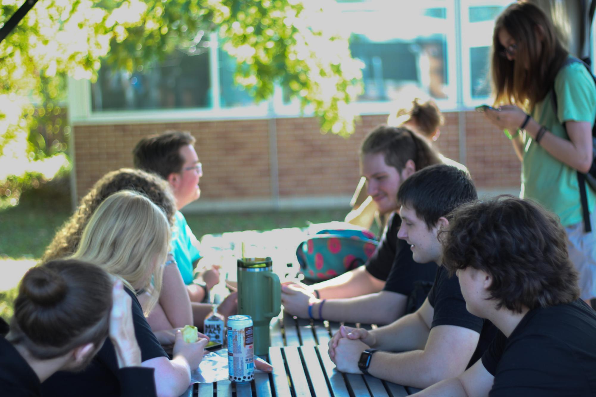 Seniors sit outside in the senior courtyard with friends during lunch to escape the loud and crowded lunchroom.