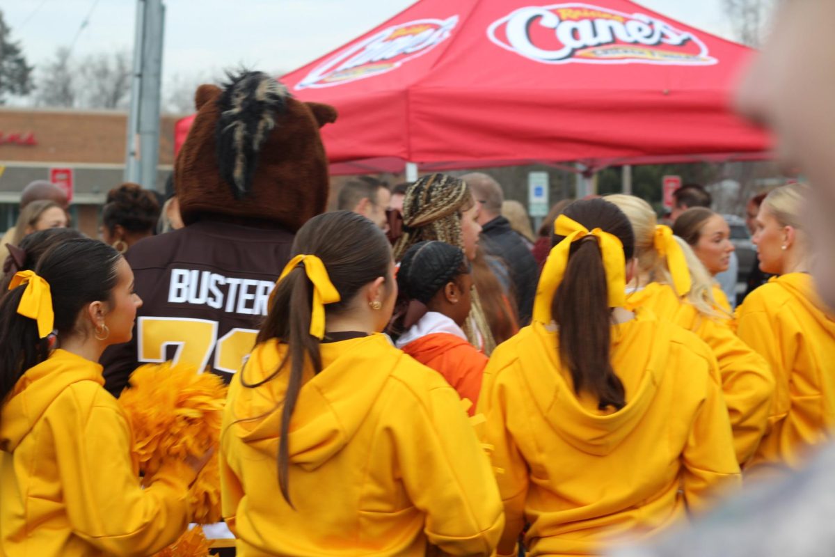 Buster Bronco and the WMU Cheer squad celebrate as Raising Cane's prepares for their grand opening. 