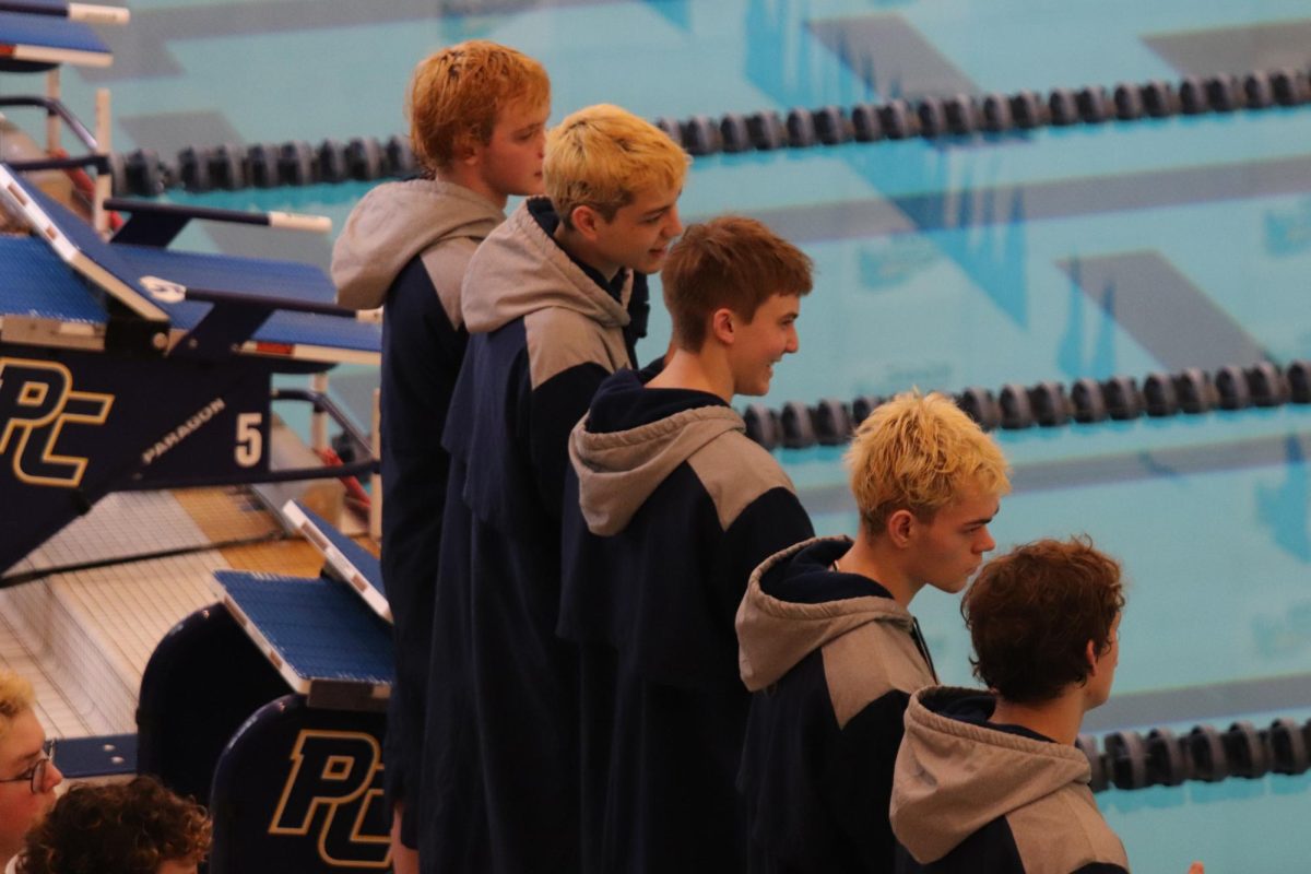 Seniors August Johnson, Gavin Lepley, Issac Patrick, Henry Freestone, and David Grubaugh mentally prepare for one of their last swim meets at the Southwestern Michigan Athletic Conference at Portage Central.