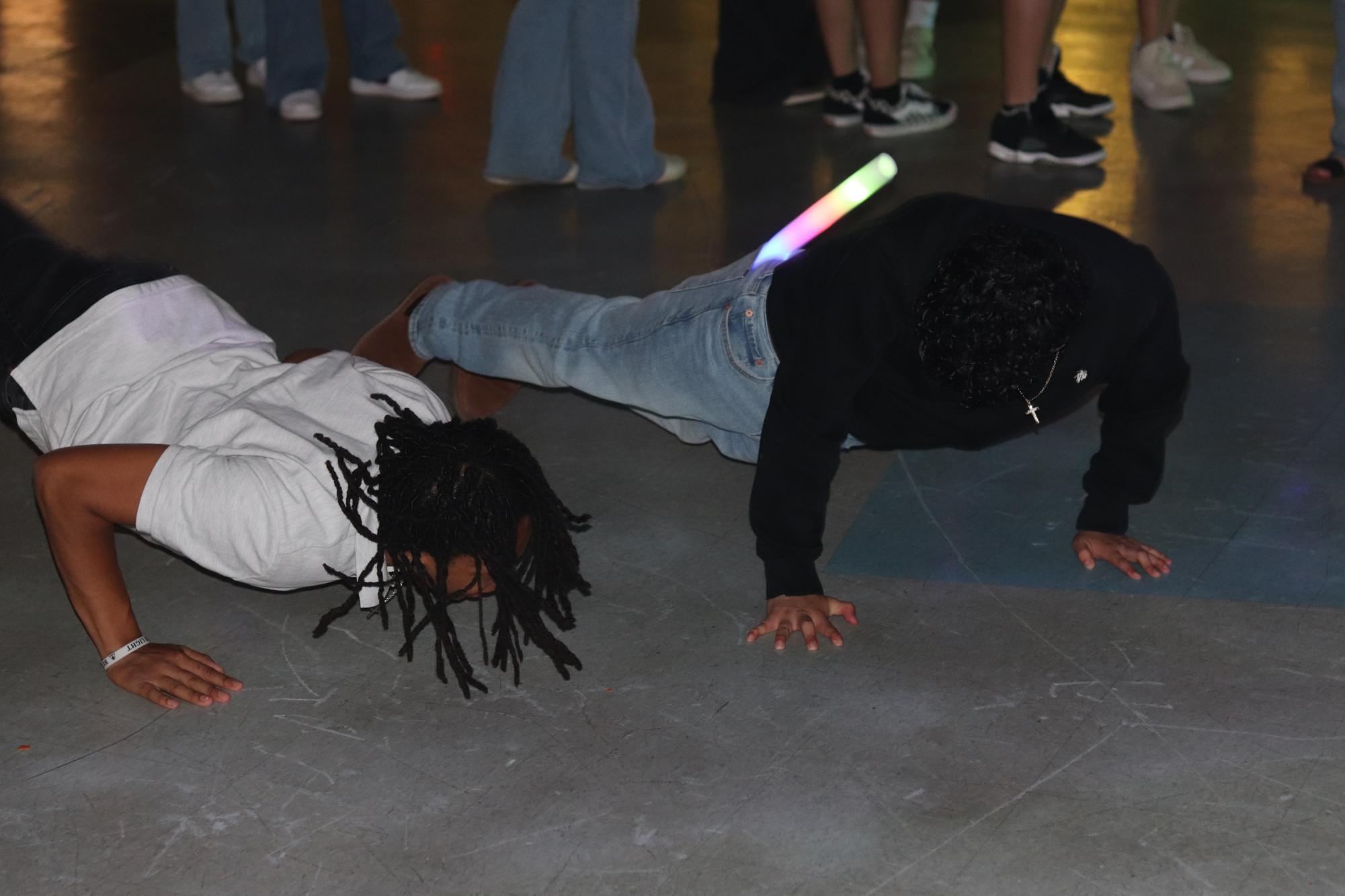 Students do the worm at the Quince Night dance